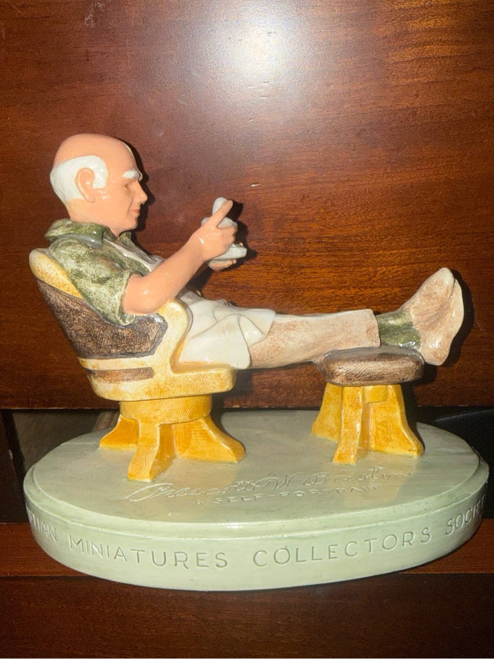 Seated Man Ceramic Figurine in Green and Cream